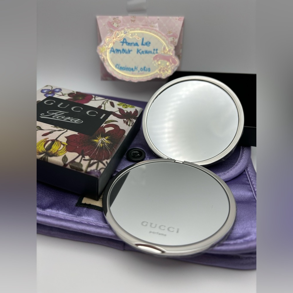 Gucci Round metal mirror with detail floral outside, and purple make up pouch